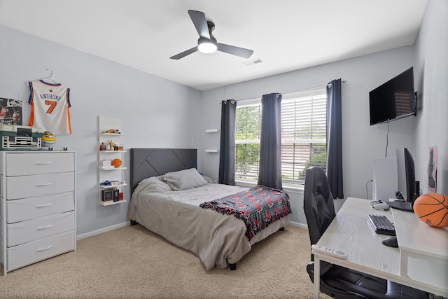 bedroom with carpet floors, baseboards, an office area, and a ceiling fan