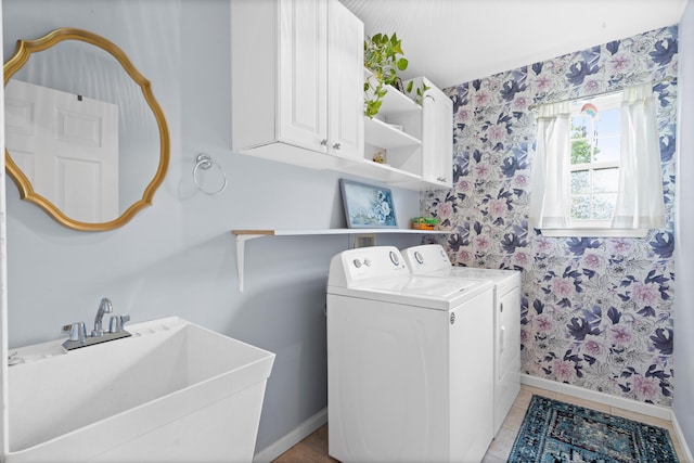 laundry area featuring wallpapered walls, cabinet space, baseboards, washer and clothes dryer, and light tile patterned flooring