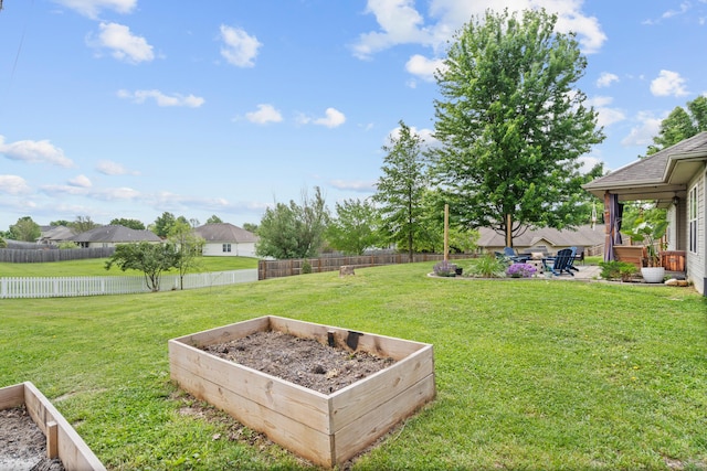 view of yard with a vegetable garden and a patio area