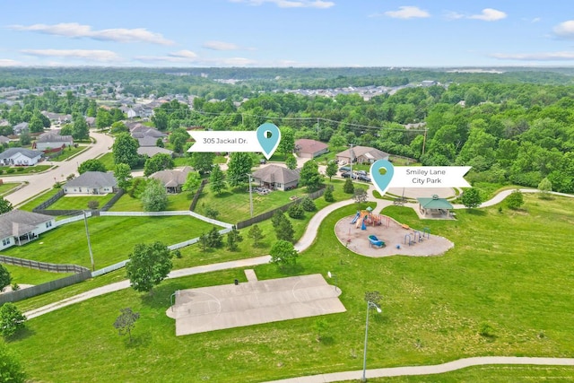 aerial view of property and surrounding area featuring nearby suburban area