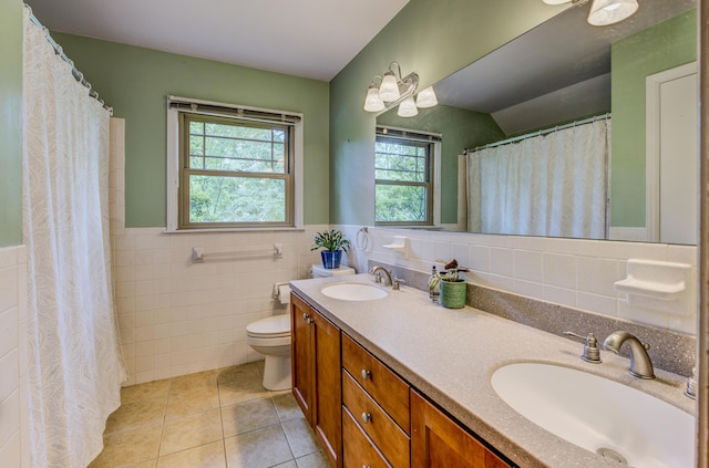 1209 Sunset Dr, Columbia, MO 65203 - bathroom with tile walls, tile patterned floors, double vanity, toilet, and wainscoting