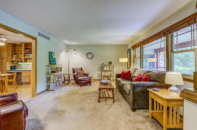 1209 Sunset Dr, Columbia, MO 65203 - living room featuring healthy amount of natural light, light colored carpet, and a ceiling fan