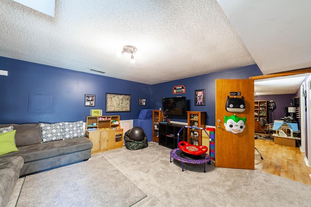 living room with carpet flooring, a textured ceiling, and an office area