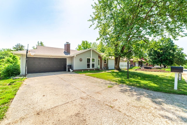 ranch-style home with a garage, a front lawn, driveway, a chimney, and roof with shingles