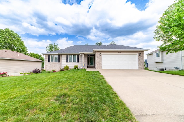 single story home featuring an attached garage, driveway, a front lawn, and cooling unit