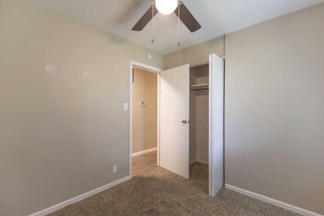 unfurnished bedroom with carpet floors, a closet, a ceiling fan, and baseboards