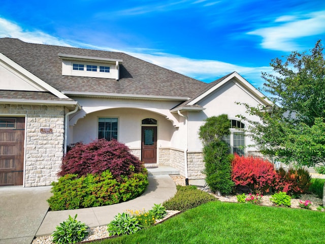 5300 Perche Pointe Pl, Columbia, MO 65203 - view of front of home with stone siding, stucco siding, and roof with shingles