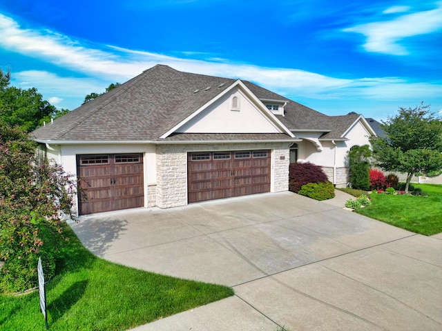 5300 Perche Pointe Pl, Columbia, MO 65203 - view of front facade with stucco siding, a garage, stone siding, concrete driveway, and a front lawn