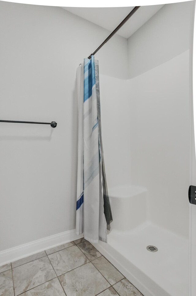 5300 Perche Pointe Pl, Columbia, MO 65203 - full bathroom featuring a shower with curtain, baseboards, and marble look tile flooring