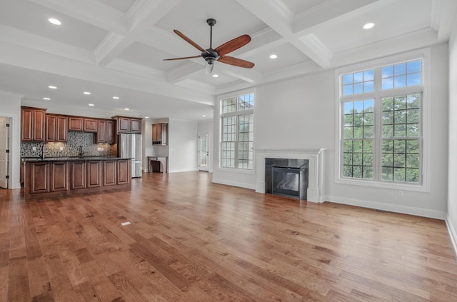 5300 Perche Pointe Pl, Columbia, MO 65203 - unfurnished living room with ceiling fan, wood finished floors, a high end fireplace, beamed ceiling, and baseboards