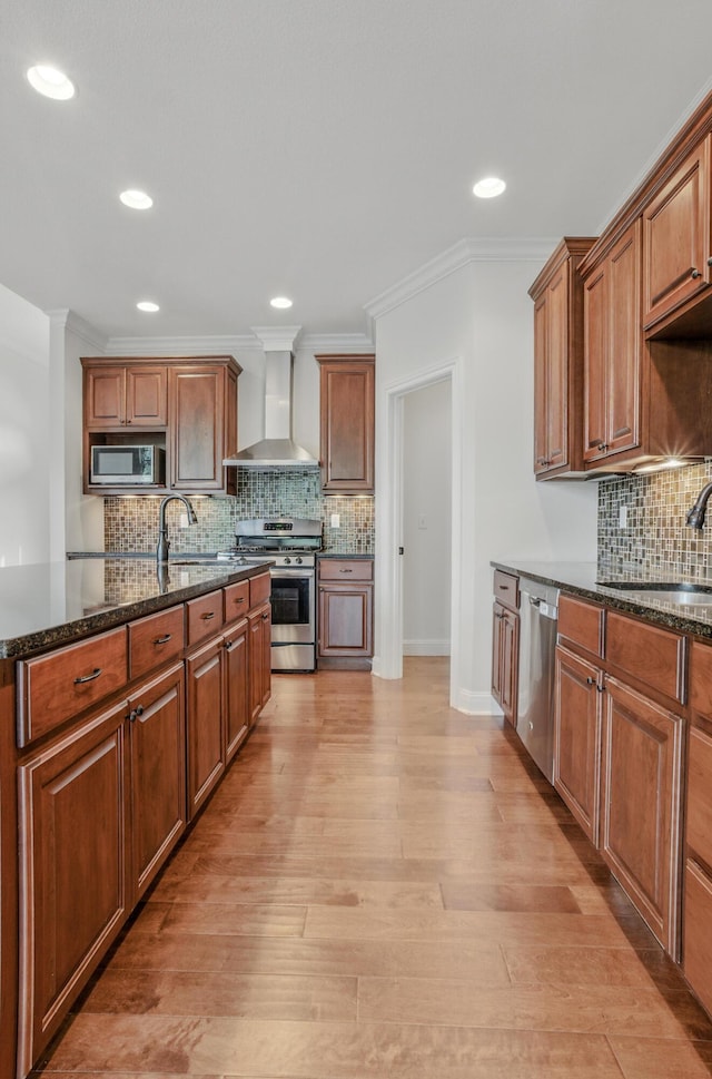 5300 Perche Pointe Pl, Columbia, MO 65203 - kitchen featuring stainless steel appliances, wall chimney range hood, a sink, tasteful backsplash, and ornamental molding
