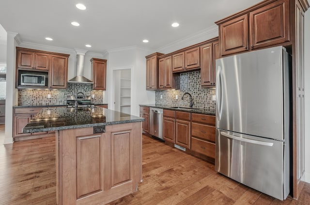 5300 Perche Pointe Pl, Columbia, MO 65203 - kitchen featuring appliances with stainless steel finishes, wall chimney range hood, a sink, crown molding, and recessed lighting