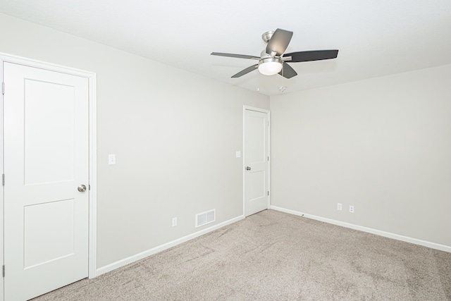 unfurnished room with carpet floors, baseboards, and a ceiling fan