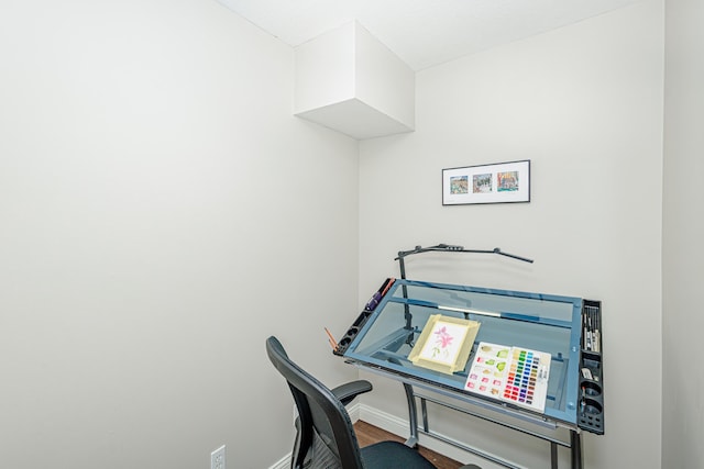 office area with wood finished floors and baseboards