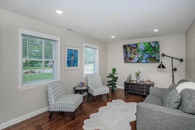 living area with dark wood finished floors, baseboards, and recessed lighting