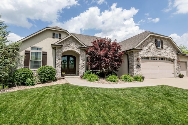 view of front facade featuring stone siding, stucco siding, a front yard, and concrete driveway