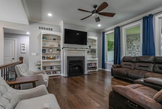 living room with a ceiling fan, dark wood-style flooring, ornamental molding, a fireplace with flush hearth, and baseboards