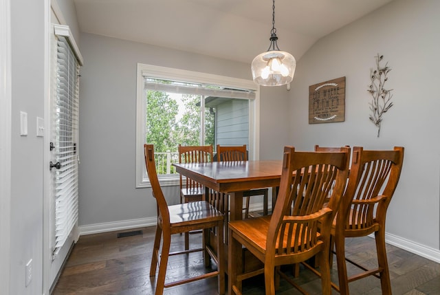 dining space with baseboards, a chandelier, lofted ceiling, and dark wood finished floors