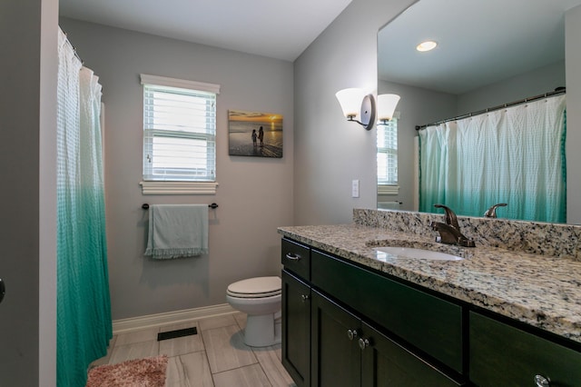 full bath with baseboards, toilet, and vanity