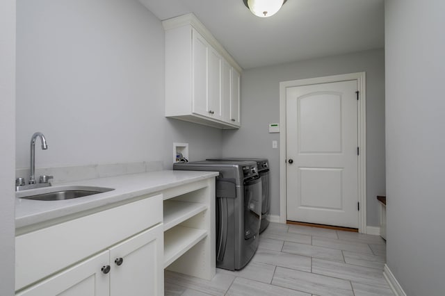 laundry room featuring cabinet space, washer and clothes dryer, and baseboards