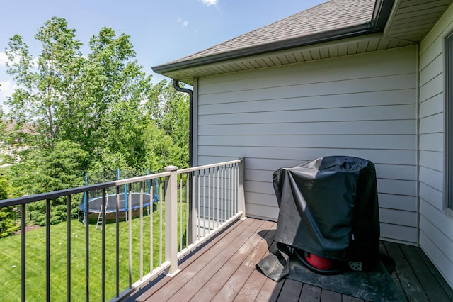 wooden deck with a grill and a yard