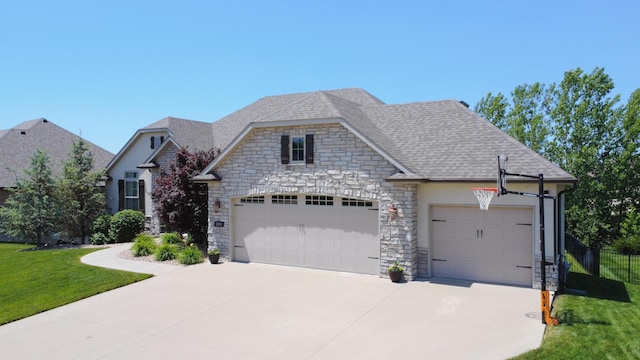 view of front of home with stone siding, a garage, driveway, and a shingled roof