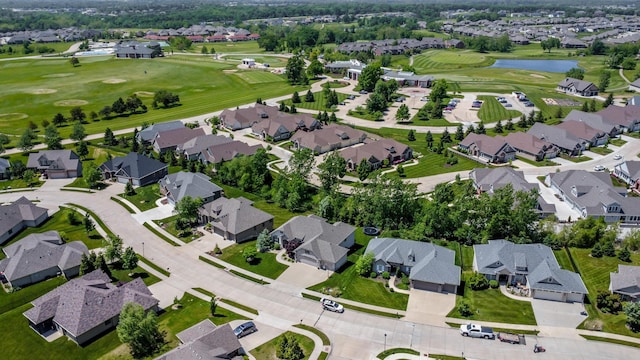 aerial overview of property's location featuring nearby suburban area, a large body of water, and a golf club