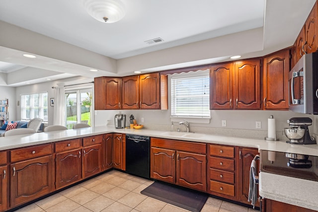 3605 Scottson Way, Columbia, MO 65203 - kitchen with black dishwasher, a sink, stainless steel microwave, light countertops, and plenty of natural light