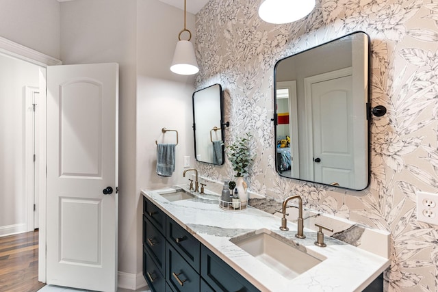 4710 Winding Wood Ct, Columbia, MO 65203 - full bathroom with double vanity, wallpapered walls, and wood finished floors