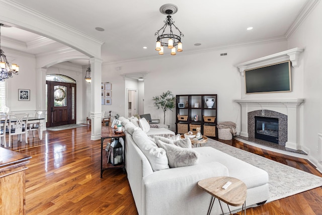 4710 Winding Wood Ct, Columbia, MO 65203 - living room with wood finished floors, decorative columns, a chandelier, arched walkways, and ornamental molding