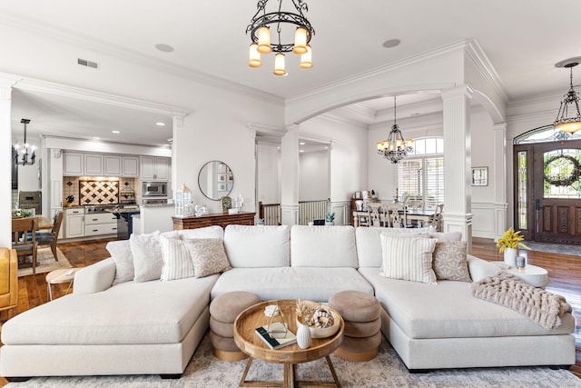 4710 Winding Wood Ct, Columbia, MO 65203 - living room with a chandelier, arched walkways, ornate columns, healthy amount of natural light, and crown molding