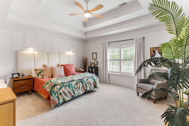 4710 Winding Wood Ct, Columbia, MO 65203 - bedroom with a tray ceiling, crown molding, light carpet, ceiling fan, and a decorative wall