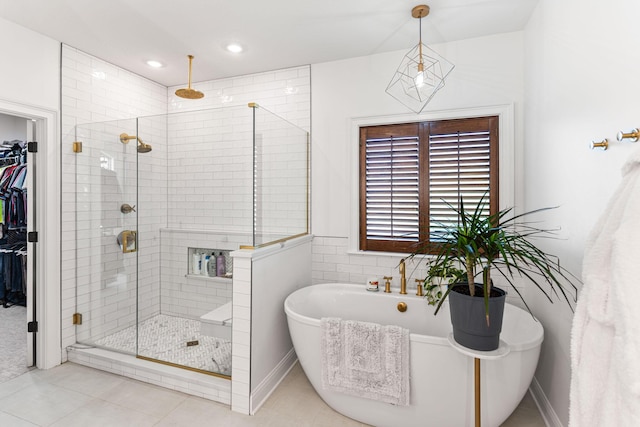 4710 Winding Wood Ct, Columbia, MO 65203 - full bath featuring a shower stall, a walk in closet, a soaking tub, and tile patterned flooring
