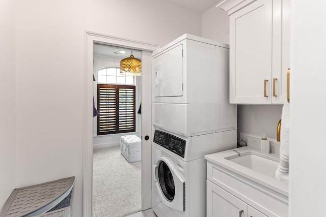 4710 Winding Wood Ct, Columbia, MO 65203 - washroom featuring estacked washer and dryer, cabinet space, and carpet