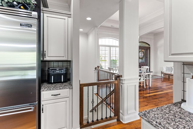 4710 Winding Wood Ct, Columbia, MO 65203 - kitchen featuring high end fridge, ornamental molding, light wood-type flooring, arched walkways, and decorative columns