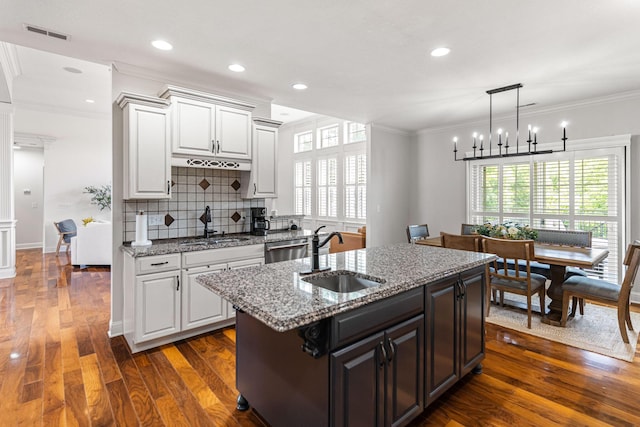 4710 Winding Wood Ct, Columbia, MO 65203 - kitchen with crown molding, tasteful backsplash, dark wood-style floors, white cabinetry, and light stone countertops