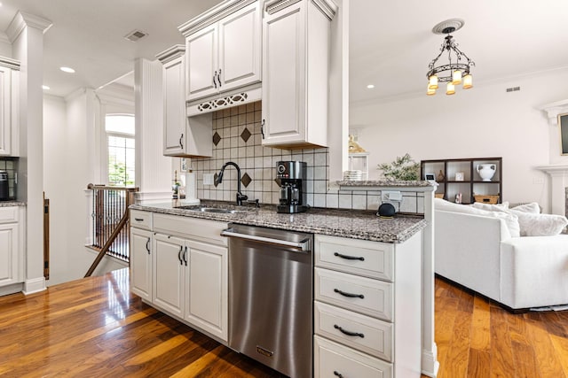 4710 Winding Wood Ct, Columbia, MO 65203 - kitchen with dishwasher, crown molding, tasteful backsplash, stone counters, and wood finished floors