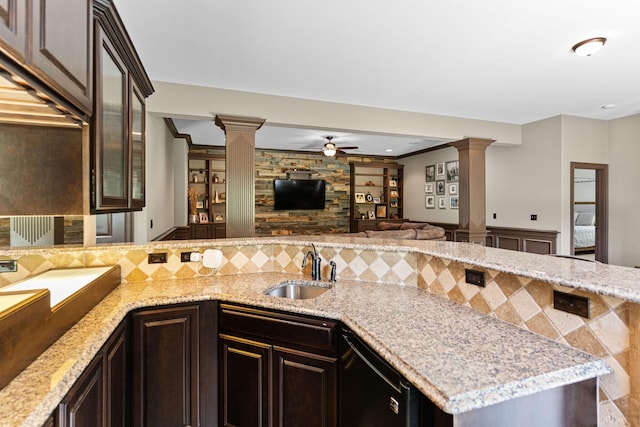 4710 Winding Wood Ct, Columbia, MO 65203 - kitchen with decorative columns, open floor plan, a ceiling fan, light stone counters, and a peninsula