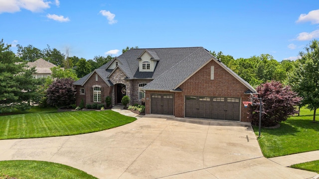 4710 Winding Wood Ct, Columbia, MO 65203 - french country home featuring concrete driveway, brick siding, and a front lawn