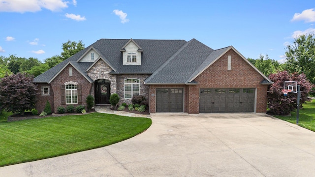 4710 Winding Wood Ct, Columbia, MO 65203 - french country inspired facade with an attached garage, a front lawn, concrete driveway, brick siding, and roof with shingles