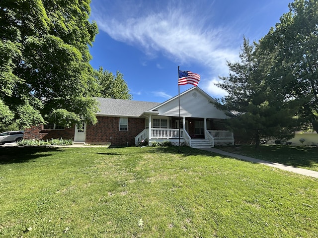705 Redwood Dr, Ashland, MO 65010 - single story home featuring covered porch, a front lawn, and brick siding