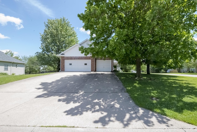 705 Redwood Dr, Ashland, MO 65010 - obstructed view of property with brick siding, a front lawn, driveway, and a garage