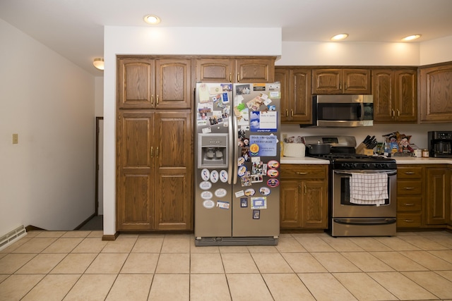 705 Redwood Dr, Ashland, MO 65010 - kitchen featuring appliances with stainless steel finishes, light countertops, light tile patterned flooring, and recessed lighting