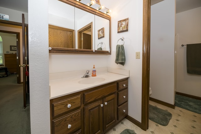 705 Redwood Dr, Ashland, MO 65010 - bathroom featuring toilet, vanity, and baseboards