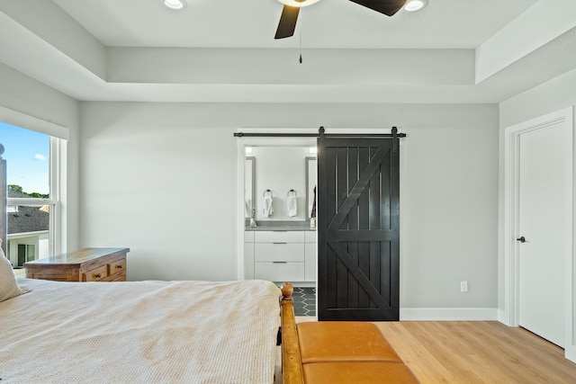 540 Angels Rest Way, Columbia, MO 65203 - bedroom with wood finished floors, baseboards, recessed lighting, connected bathroom, and a barn door