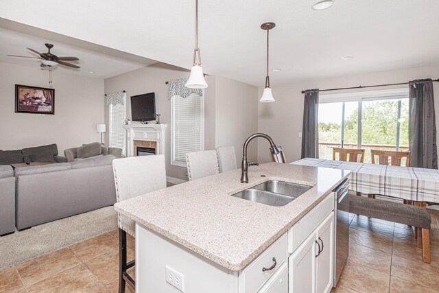 4105 Astoria Way, Columbia, MO 65203 - kitchen with a sink, open floor plan, a ceiling fan, white cabinets, and a kitchen island with sink