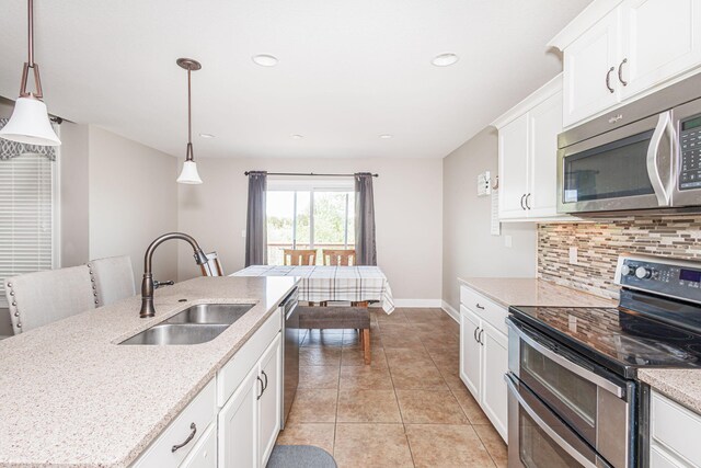 4105 Astoria Way, Columbia, MO 65203 - kitchen featuring appliances with stainless steel finishes, a sink, backsplash, light tile patterned floors, and white cabinets