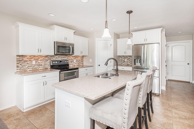 4105 Astoria Way, Columbia, MO 65203 - kitchen with stainless steel appliances, a sink, a kitchen bar, tasteful backsplash, and a center island with sink