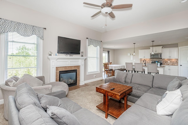 4105 Astoria Way, Columbia, MO 65203 - living area with ceiling fan, baseboards, a tiled fireplace, and light colored carpet