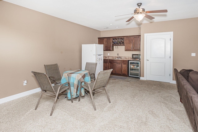 4105 Astoria Way, Columbia, MO 65203 - dining area with beverage cooler, bar with sink, light colored carpet, ceiling fan, and baseboards